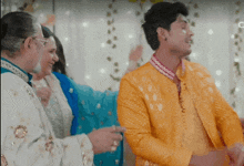 a man in a yellow jacket is dancing in front of a woman
