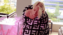 a woman is wrapped in a black and white blanket with the letters ff on it