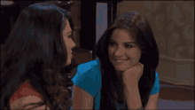 two women are looking at each other and smiling for the camera