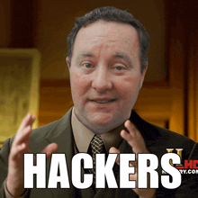 a man in a suit and tie says hackers in front of him