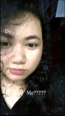 a close up of a woman 's face with the words do you love me written on it
