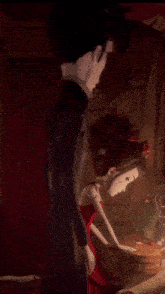 a man and a girl are standing next to each other in a dark room