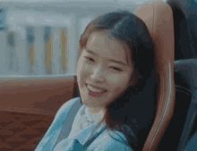 a woman is sitting in the back seat of a car and smiling
