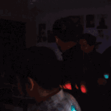 a man in a blue shirt is standing in a room with other people
