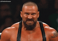 a man with a beard is making a funny face with the hashtag thekamdreesen behind him