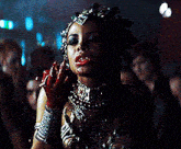 a woman with blood on her face is wearing a fancy costume