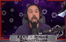 a man wearing headphones and a name tag that says kent rogue on it