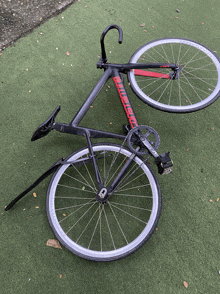 a black and red bicycle with the word bicycle on the front