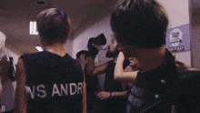 a person wearing a black tank top that says ns andr