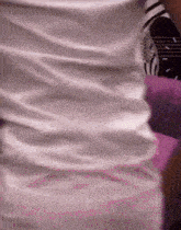 a person wearing a white shirt with a black and white logo on it