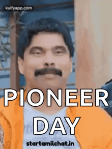 a man with a mustache is standing in front of a sign that says pioneer day .