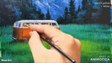 a person is painting a van in a field with lemon yellow and white paint