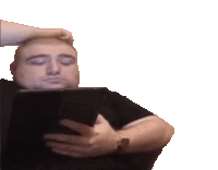 a man with his eyes closed is holding a tablet in his hands