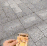 a person is holding a piece of paper with a face on it