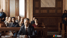 a man in a suit sits in a courtroom with a nbc logo on the bottom