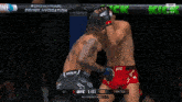 two men are fighting in a ufc ring and the ufc logo is on the screen