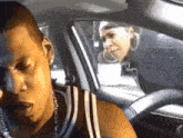 a man and a woman are in a car talking