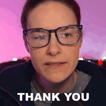 a woman wearing glasses says " thank you " in front of her face