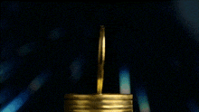 a stack of gold coins with a btc moneytalks logo behind it