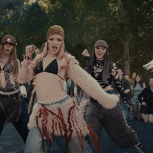 a woman wearing a ny hat is dancing with a group of other women