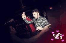 a man in a polka dot shirt is dancing with a woman