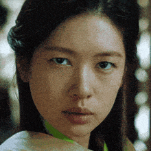 a close up of a woman 's face with a serious look on her face