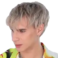 a close up of a young man 's face with blonde hair and a yellow shirt .