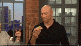 a man is eating a sandwich with the number 5 on the bottom right