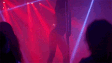 a woman dancing on a pole in front of a crowd