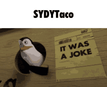 a picture of a penguin next to a sign that says it was a joke