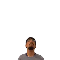 a man with glasses is looking up at a green cross on his head