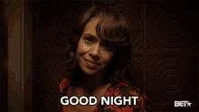 a woman says " good night " in front of a bet logo