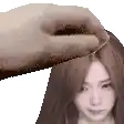 a hand is touching a woman 's head .