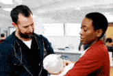 a doctor and nurse are holding a baby in a hospital room .