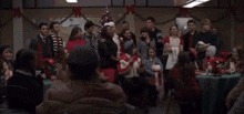 a group of people gathered around a christmas tree