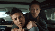 a man and a woman in a car with the word prime on the bottom left