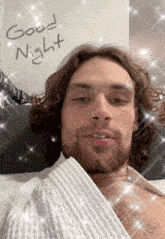 a man with long hair and a beard is wearing a white robe and says good night