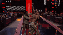a ring of honor sign is behind two wrestlers on a stage