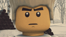 a close up of a lego figure 's face with a serious look on his face