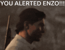 a man holding a gun with the words you alerted enzo below him