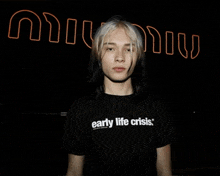 a young man wearing an early life crisis shirt