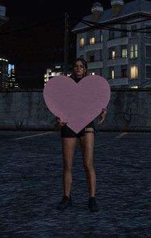a woman holds a large pink heart in front of a building that says shop