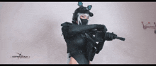 a woman is holding a gun with the word cosplay on the bottom
