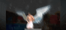 a blurred image of a man with angel wings .