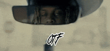 a man is looking at himself in a rear view mirror with the word ott written on it