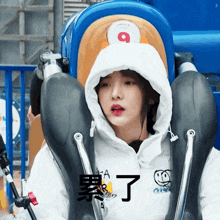 a girl in a white hoodie is riding a roller coaster with the number 9 on it