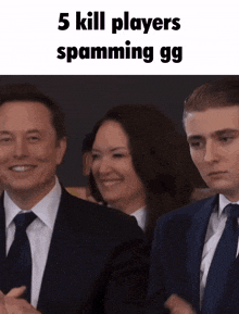 a man in a suit and tie stands next to a woman and another man
