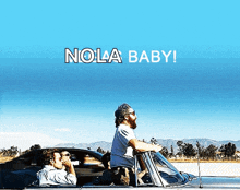 a man in a car says nola baby