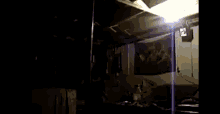 a man is falling from the ceiling of a dark room