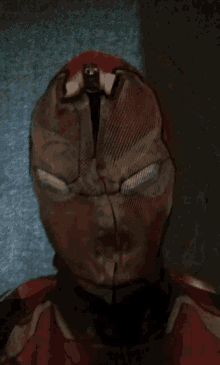 a close up of a person wearing a spider man costume